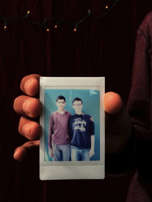 Senior Preetham Gujjula holds a polaroid of him and junior Willy Chao. The two received the picture for free after helping set up.