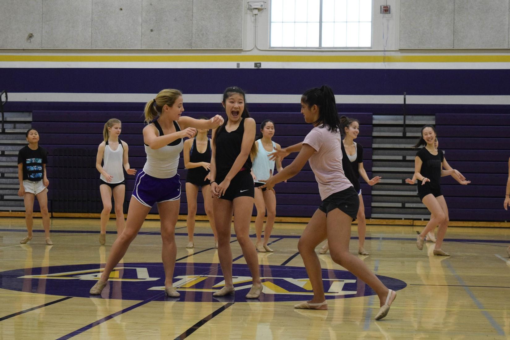 Junior Jessica Kimm and seniors Linnea Cheek and Riona Guha, who is a captain for the Marquesas, rehearse a section of the routine. The humorous choreography gave the Marquesas the chance to show a sense of camaraderie in their team throughout their dance. 