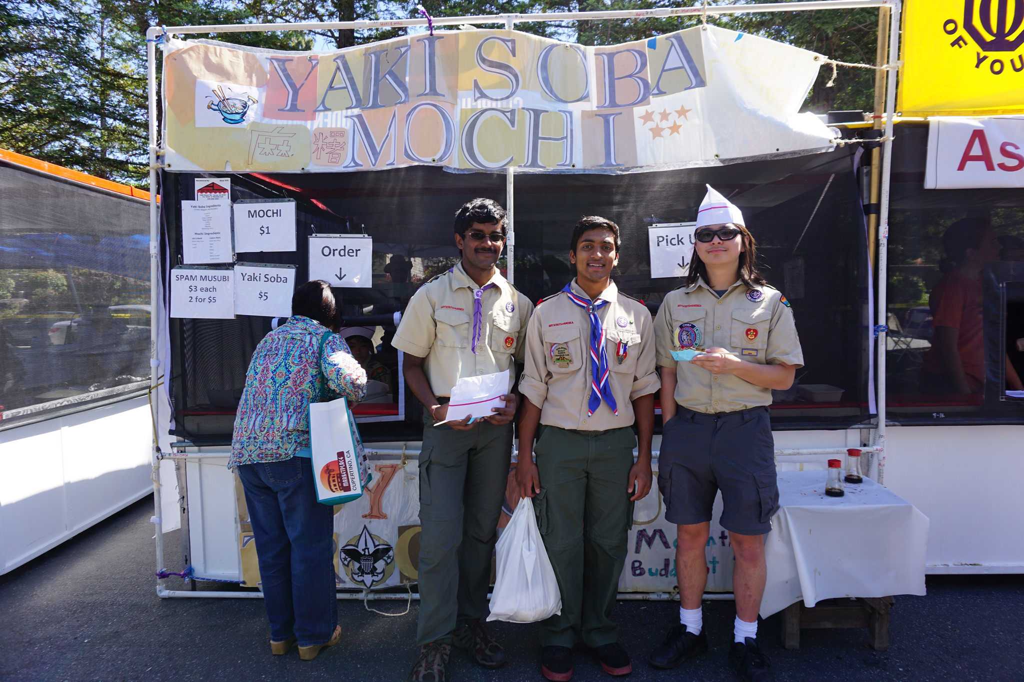 Scouts from Boy Scout Troop 487 stand in front of their Yakisoba Stand. Troop 487 reserves a stand at the Cherry Blossom Festival every year.