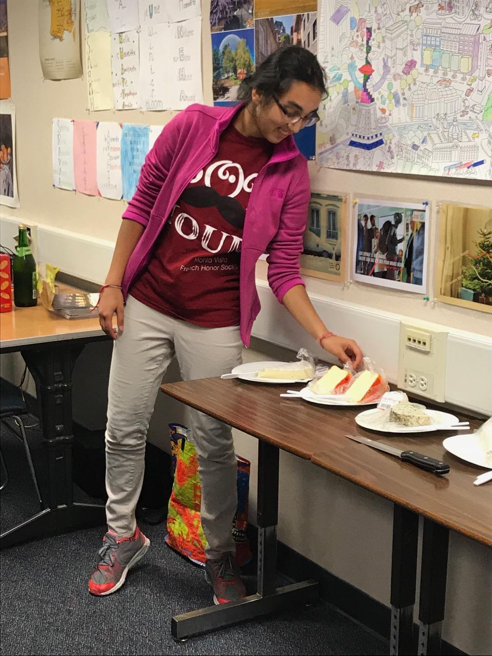 Senior Anika Ramachandran introduces the different types of cheeses. Ramachandran said that FHS' officers had to do research to make sure that all the cheeses were French.
