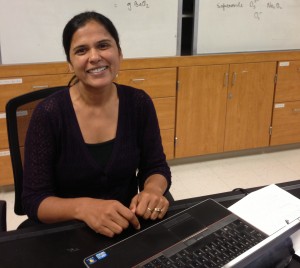 Kavita Gupta sits at her desk in her AP Chemistry classroom. AP Chemistry students used her iBook in class to learn and quiz themselves on the lesson. Photo by Lydia Seo.