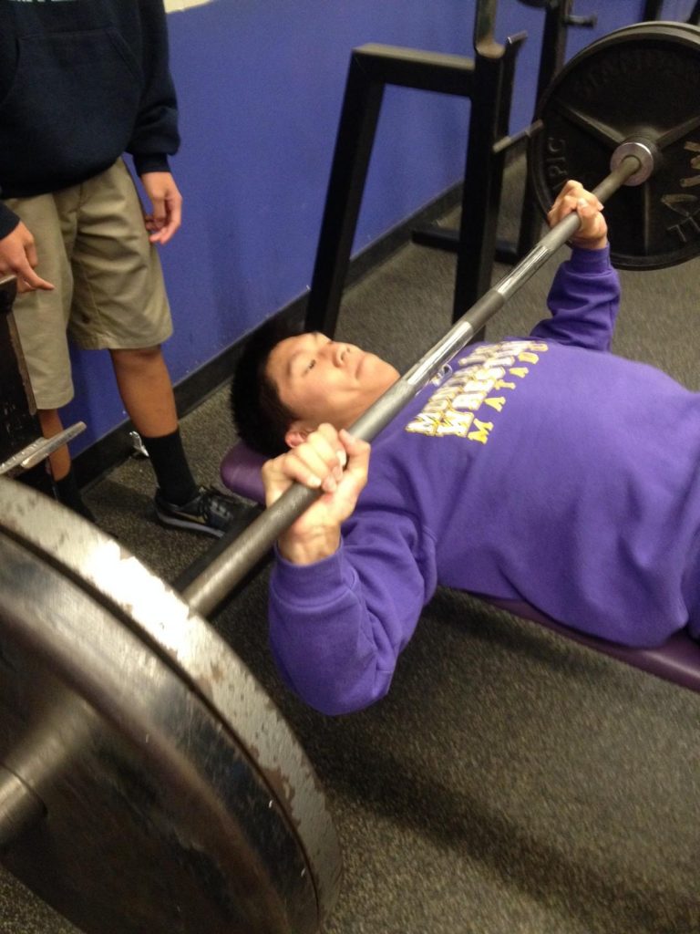 Senior co-captain Aaron Wu, a three-year wrestler and returning CCS qualifier for MVHS, prepares for the upcoming season with his teammates in the weight room. He has been training through the entire offseason with the year-round wrestling club. Photo by Alaina Lui. 