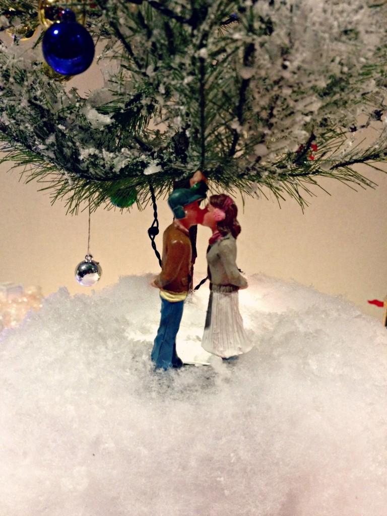 Two figurines kiss under a glowing, snow-dusted tree in sophomore Michaela Murphy’s miniature representation of the fictional town of Almost. ‘Almost, Maine’ features nineteen characters in nine different vignettes, who in wandering through a snowy, mystical place, find themselves kissing — or crying over — people they love. Photo by Anjali Bhat.