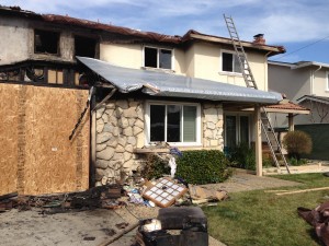 Construction workers work in and around the house on the morning after the fire. Photo by Joyce Varma.