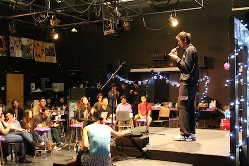 Sophomore Evan Zhang sings at the La Pluma Coffeehouse. The event featured a variety of acts including singing, dancing and role play. Photo by Varsha Venkat.