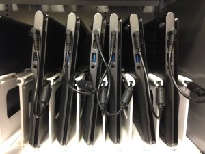 Mini chromebooks are arranged and plugged into the built-in chargers on a shelf inside of a chromebook cart. The implementation of these technologies is a contributing factor as to why MVHS has become a “Google school”. Photo by Neha Patchipala 
