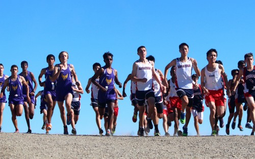 The varsity boys were the first to take off at 3:15 p.m. After the gunshot went off, the lined-up runners sped downhill for the first half-mile. Photo by Sharon Tung.  
