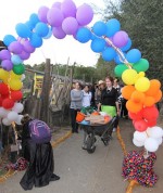 Volunteers and Hidden Villa interns set up the lights of a fluorescent rainbow of balloons, which would hang over the beginning of the Yellow Brick Road.  Later, as her group passes under the rainbow, Joshi shouts, “Let’s follow the Yellow Brick Road!”  Photo by Dylan Tsai.