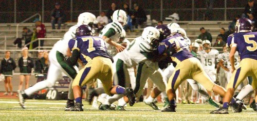 Wells Chang, player 75, blocks two PAHS during homecoming game in which he received his first concussion. Photo by Trisha Kholiya.