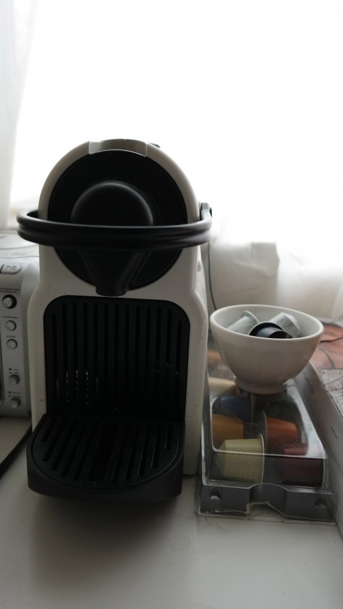 Leung's Nespresso machine sits by the window, coupled with small cups of espresso flavors. Leung drinks a cup of espresso every morning. Photo by Rhonda Mak