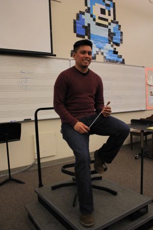 Music teacher Ricky Alegria holds the baton he uses to conduct the bands. Alegria joined the MVHS Music  Department in early February. Photo by: Justin Kim. 