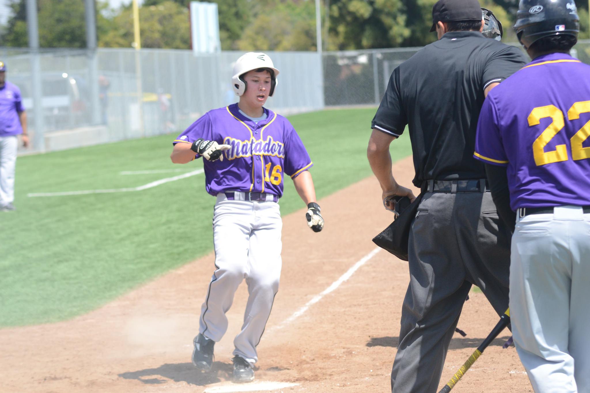 Sophomore Brendan Hughes crosses homeplate to give the Matadors the edge. This was was much needed momentum for them to be in the drivers seat and be able to shake off the butterflies. Photo by Pranav Iyer