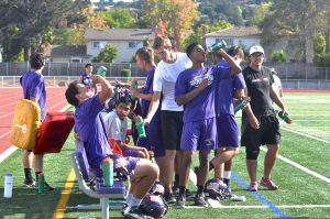 The football boys take a water break during practice on Sept. 10. Head coach Jeff Mueller makes sure to included water breaks every 15 minutes to keep the team hydrated. Photo by Malini Ramaiyer. 
