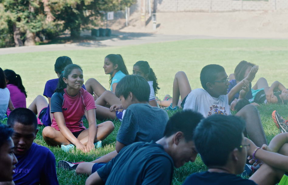 Freshman Anushka Tandon sits amongst her cross country teammates. On Sept. 11, he team practiced at Linda Vista Park for the shade there. Photo by Malini Ramaiyer