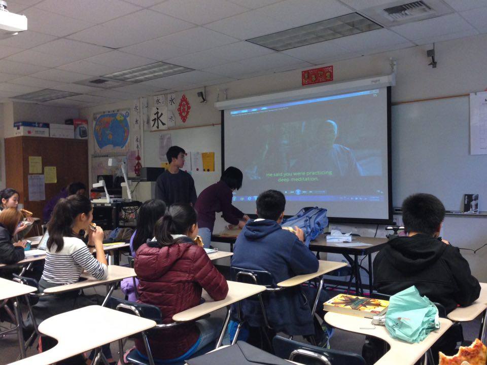 Members of CHS watch the screen attentively as officer and junior Nathan Wong and Chinese teacher Kathy Wang make final adjustments to the movie projector. The film gave a glimpse into what life and society were like in ancient China. Photo taken by Sneha Gaur