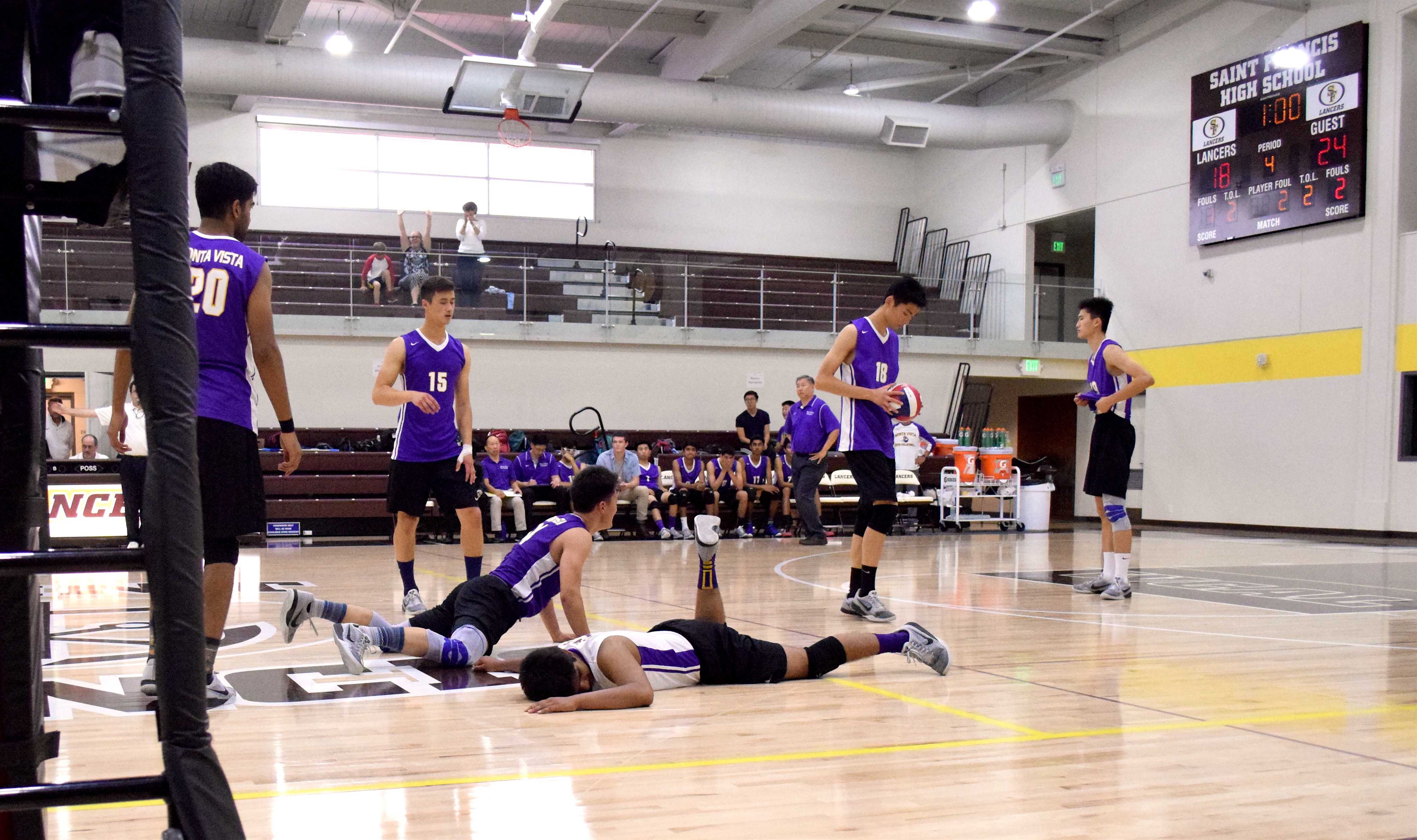Sophomore Jason Shen and junior Prathik Rao lay on the court in shock, after missing a short ball and losing the match point. On May 14, the team lost to Bellarmine College Preparatory in the CCS semifinals 3-1. Photo by Om Khandekar
