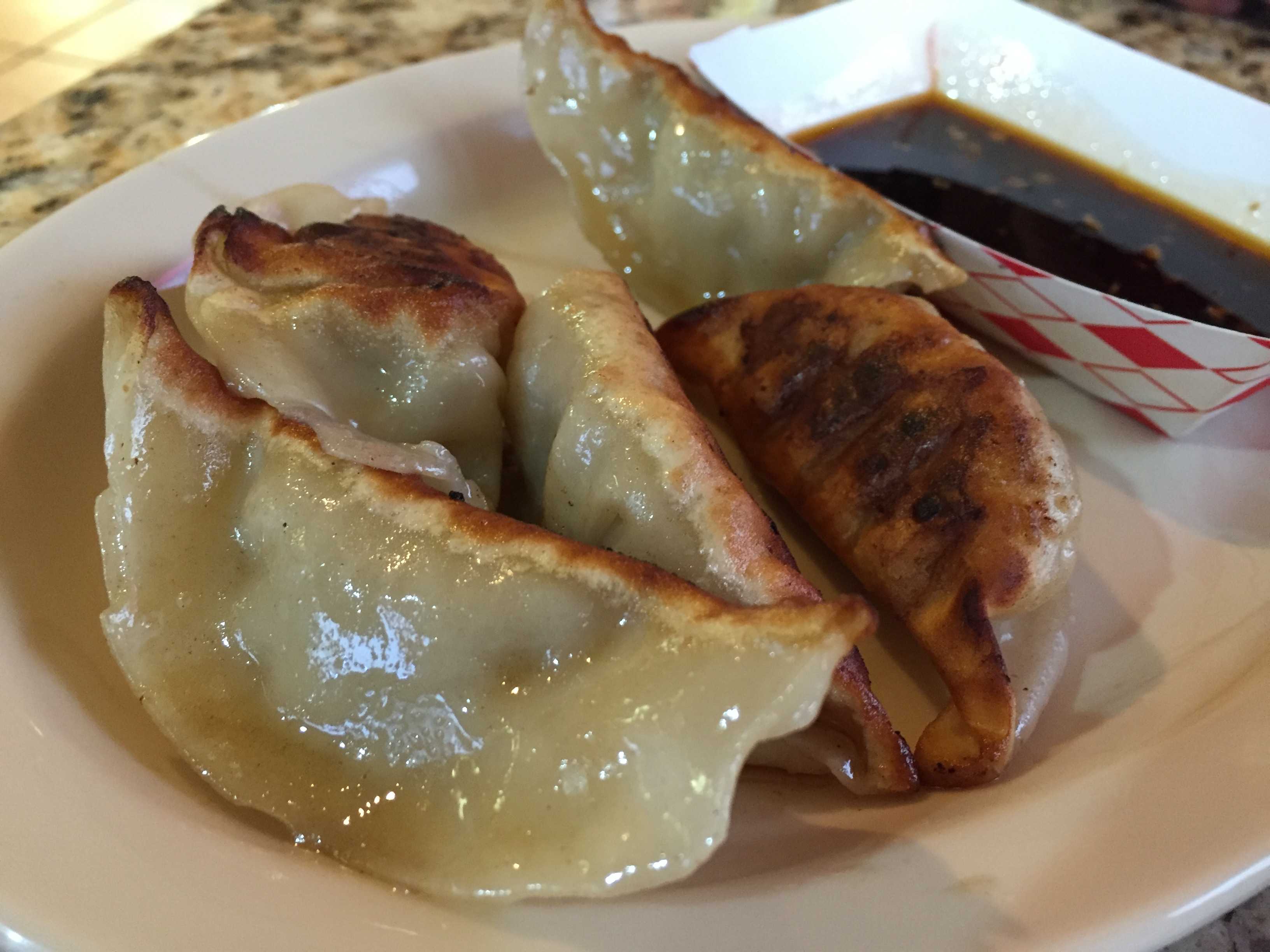 The potstickers’ slightly burnt bottom-sides glisten with oil. Their price is $3.50. Photos by Caitlyn Tjong.