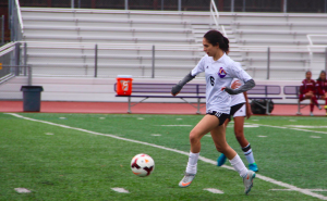 Senior Rebecca Noordeen dribbles up the field preceding the goal by freshman Skylar Ploshay. The team did well to find open players and move the ball up fast up the field. Photo by Jasmine Lee. 