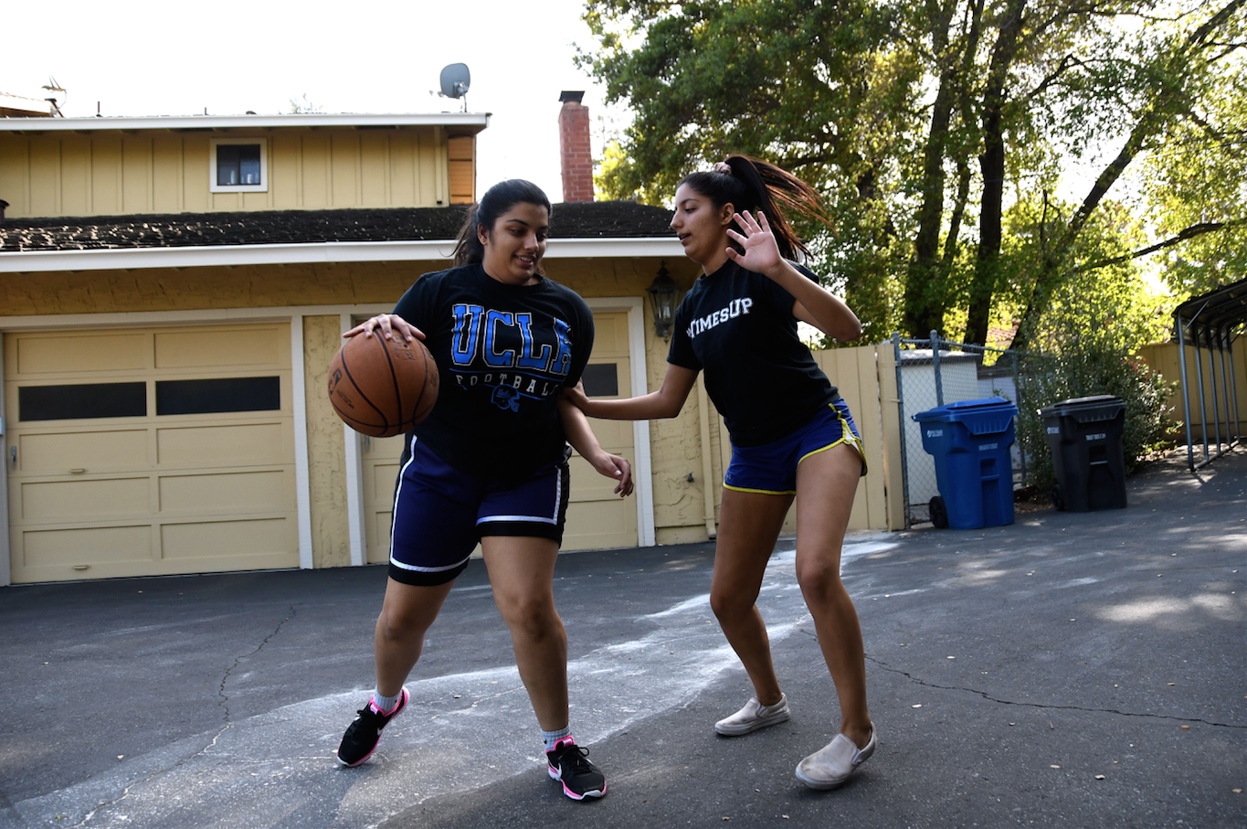 Senior twins Priyanka and Rupali Sujan play one on one in their front yard. They play regularly both for fun and to help each other improve particular skills. 