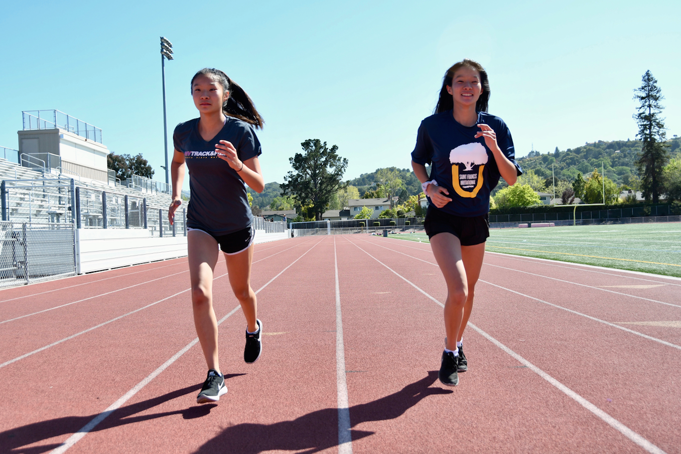Freshman twins Brooke and Bianca Young run alongside one another. Photo by Roshan Fernandez.